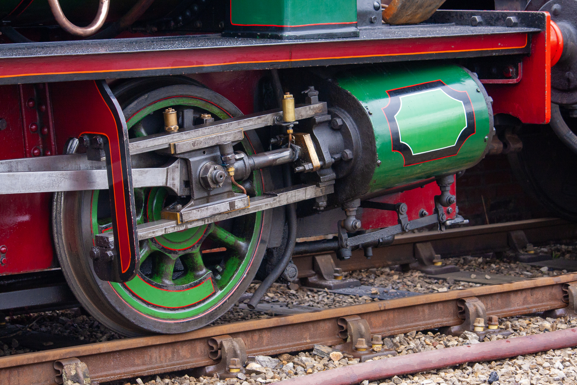 Closeup photograph of the piston of a steam locomotive.